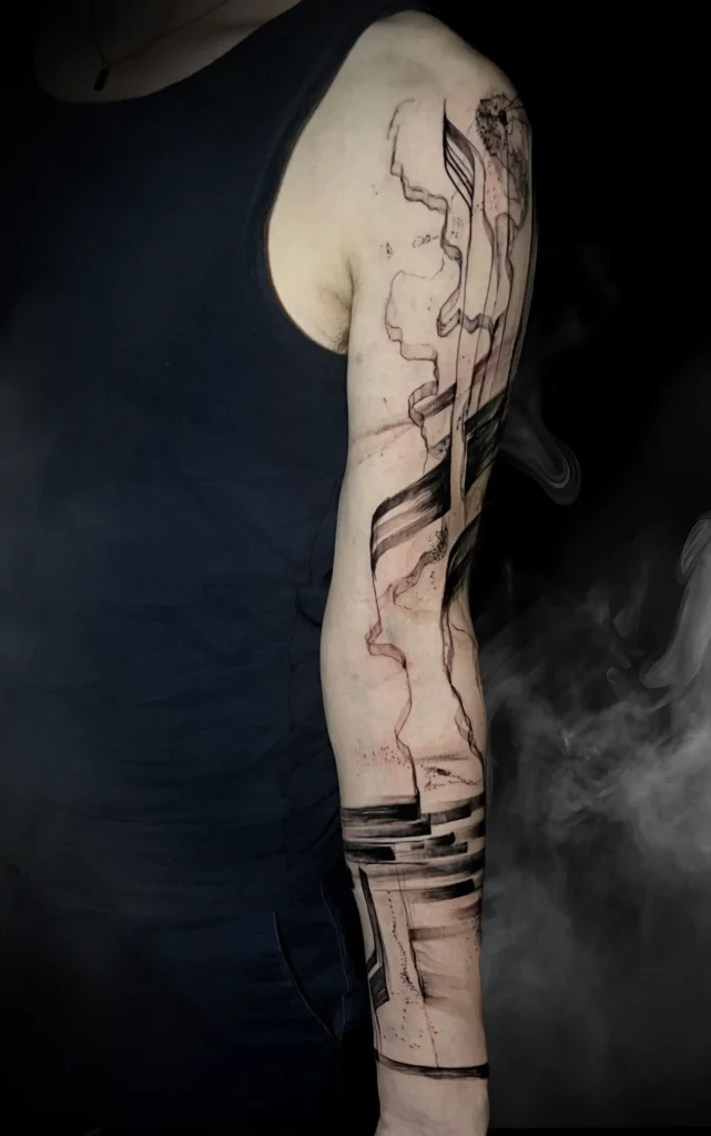 Abstraktní černé tetování na paži od tatéra MR. K-INK ze studia Magic Tattoo v Praze.